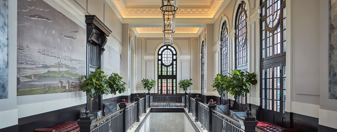 Hotel lobby with large windows, part of the real estate portfolio by hotelAVE, offering hospitality investment services